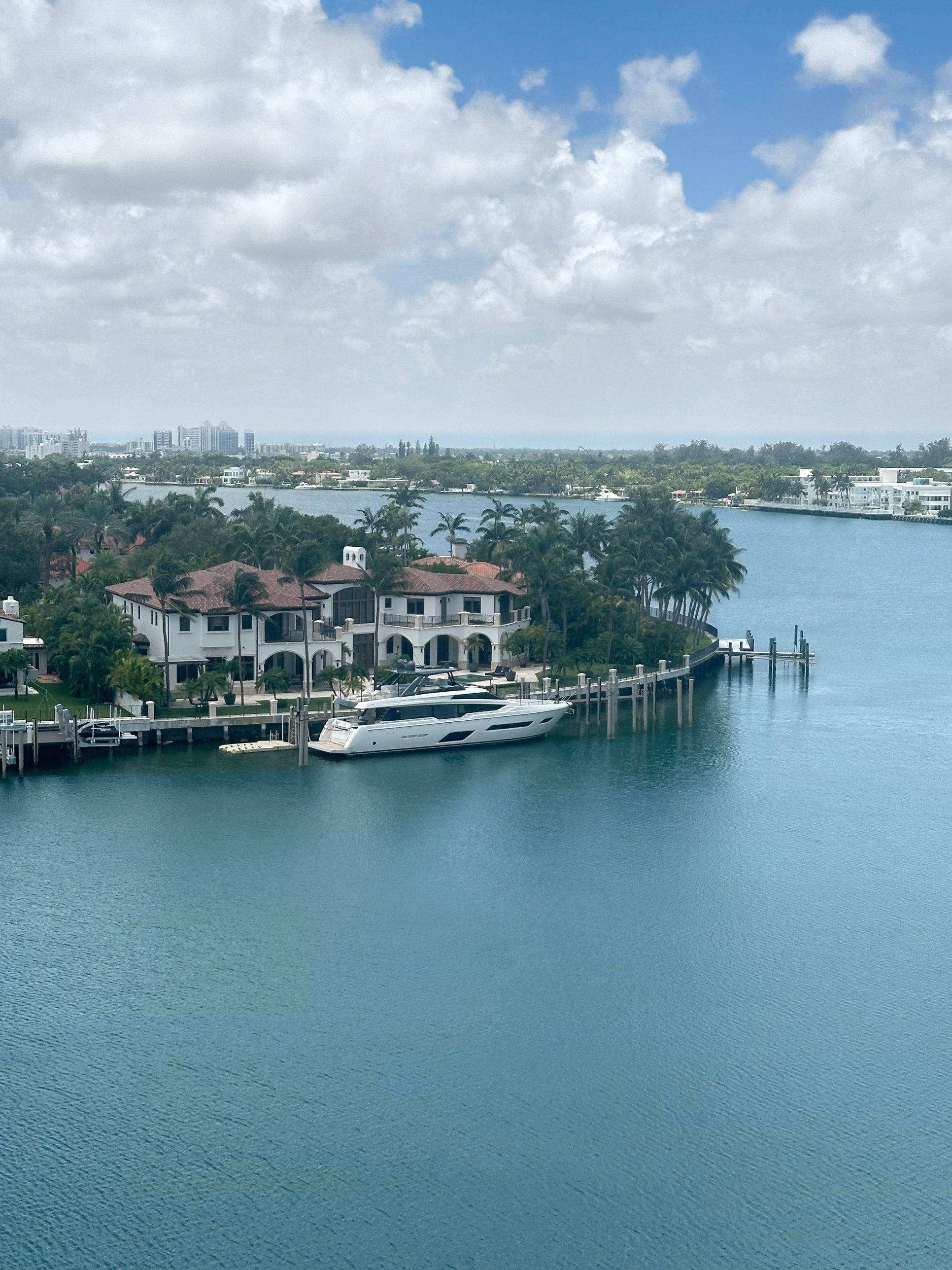 Waterfront home and yacht on Biscayne Bay, photographed by Andrea